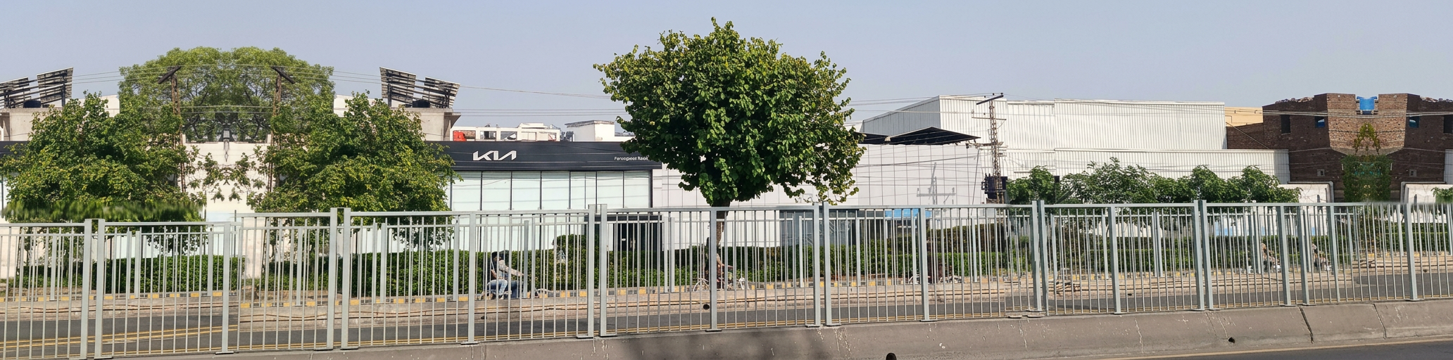 Kalma Motors site viewed from Model Town Park, showing the showroom and service frontage on Ferozepur Road
